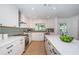 Bright kitchen with white cabinets, stainless steel appliances and an island at 4106 W Fielder St, Tampa, FL 33611