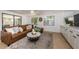 Inviting living room with brown sofa, stylish rug, and access to the outdoor area at 4106 W Fielder St, Tampa, FL 33611
