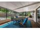 Enclosed patio with lovely blue rug and matching cushions to relax and enjoy the outside at 4106 W Fielder St, Tampa, FL 33611