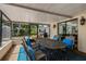 Enclosed patio features dining table and overlooks the backyard at 4106 W Fielder St, Tampa, FL 33611