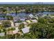 Beautiful aerial view of waterfront homes with docks, and city views in the distance at 4304 N River View Ave, Tampa, FL 33607