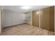 Bedroom with wood-look floors, a closet, and white brick walls and a window at 4304 N River View Ave, Tampa, FL 33607