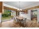 Bright dining room featuring wood floors, sliding glass doors to the outdoors, and a modern light fixture at 4304 N River View Ave, Tampa, FL 33607