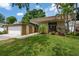 Modern home featuring a well-manicured lawn and a stylish contemporary design with a side-entry two car garage at 4304 N River View Ave, Tampa, FL 33607