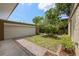 Landscaped front yard with a grass area and manicured landscaping in a mulch bed in front of the garage at 4304 N River View Ave, Tampa, FL 33607