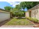 Landscaped front yard with a grass area and manicured landscaping in a mulch bed in front of the home at 4304 N River View Ave, Tampa, FL 33607