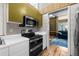 Modern kitchen with white countertops, stainless steel appliances, and an open doorway to the living room at 4304 N River View Ave, Tampa, FL 33607