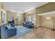 Bright living room featuring hardwood floors, comfortable seating, and shelving for an airy and inviting atmosphere at 4304 N River View Ave, Tampa, FL 33607