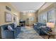 Open-concept living room with neutral colors, hardwood flooring and two blue sofas for a relaxing and stylish living space at 4304 N River View Ave, Tampa, FL 33607