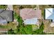 Aerial view showcasing the roof and backyard, along with nearby houses, providing a glimpse of the neighborhood at 4709 Mineola St, Bradenton, FL 34207