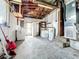 Basement area with white walls, concrete floor, laundry appliances, and exposed ceiling structure at 4709 Mineola St, Bradenton, FL 34207