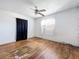Bedroom with hardwood floors, a ceiling fan, and a window with sheer curtains at 4709 Mineola St, Bradenton, FL 34207