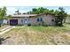 Cozy single-story home featuring a front lawn and a one-car garage, with mature trees for added privacy at 4709 Mineola St, Bradenton, FL 34207