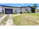Charming single-story home with a front lawn and a one-car garage, set against a bright blue sky at 4709 Mineola St, Bradenton, FL 34207