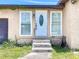 Inviting front entrance with a decorative door, flanked by windows, and a small set of steps at 4709 Mineola St, Bradenton, FL 34207