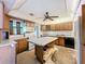Large kitchen with wood cabinets, expansive countertops, a center island, and white appliances at 4709 Mineola St, Bradenton, FL 34207