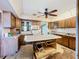 This large kitchen showcases ample wood cabinets, countertops, a center island, and appliances, ready for updates at 4709 Mineola St, Bradenton, FL 34207