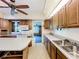 Traditional kitchen layout with ample counter space, wooden cabinets, and a peninsula island for additional seating at 4709 Mineola St, Bradenton, FL 34207