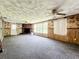 The living room features a fireplace, a large window, and wall paneling that needs repair at 4709 Mineola St, Bradenton, FL 34207