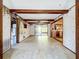 Spacious living room with exposed beams, connecting to a kitchen and a screened-in patio through sliding glass doors at 4709 Mineola St, Bradenton, FL 34207