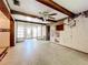 The living room features decorative wood beams, a front door entry, and walls that need repair at 4709 Mineola St, Bradenton, FL 34207