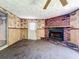 Living room showcasing a classic brick fireplace and access to the outdoors at 4709 Mineola St, Bradenton, FL 34207