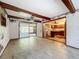 Bright living room with exposed beams that connects to a kitchen and a screened-in patio through sliding glass doors at 4709 Mineola St, Bradenton, FL 34207