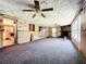 Spacious living room featuring a brick fireplace, ceiling fans, and sliding glass door at 4709 Mineola St, Bradenton, FL 34207