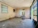 Enclosed patio with concrete flooring, stucco walls, and a sliding glass door at 4709 Mineola St, Bradenton, FL 34207