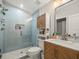 Modern bathroom features a glass-enclosed shower, vanity, and cabinet, offering a clean and functional space at 4710 W Tambay Ave, Tampa, FL 33611