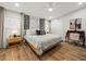 Comfortable bedroom featuring hardwood floors, soft lighting, and stylish desk, creating a cozy and relaxing atmosphere at 4710 W Tambay Ave, Tampa, FL 33611