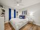 Bright bedroom featuring hardwood floors, stylish decor, and a cozy double bed, creating a restful retreat at 4710 W Tambay Ave, Tampa, FL 33611