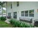 Charming home exterior with a cozy outdoor seating area and lush landscaping, perfect for relaxing at 4710 W Tambay Ave, Tampa, FL 33611