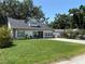 Charming home featuring a well-manicured lawn, a quaint porch, and an inviting exterior at 4710 W Tambay Ave, Tampa, FL 33611
