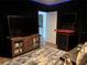Unique game room boasts a vintage arcade game, large screen tv, and home theater seating for entertainment at 4710 W Tambay Ave, Tampa, FL 33611