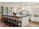 Open kitchen boasts a spacious island, modern pendant lighting, and sleek white cabinetry at 4710 W Tambay Ave, Tampa, FL 33611