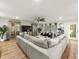 Spacious living room featuring a large sectional sofa, hardwood floors, and stylish decor at 4710 W Tambay Ave, Tampa, FL 33611