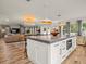 Open floor plan connecting the kitchen, dining, and living areas, perfect for entertaining at 4710 W Tambay Ave, Tampa, FL 33611