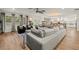 Open concept living room and kitchen area with hardwood floors, ceiling fan, and plenty of natural light at 4710 W Tambay Ave, Tampa, FL 33611
