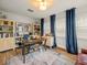 Well-lit home office with built-in bookshelves, a large desk, and comfortable seating at 4710 W Tambay Ave, Tampa, FL 33611