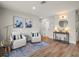 Inviting sitting area with stylish chairs, a console table, and decorative art at 4710 W Tambay Ave, Tampa, FL 33611
