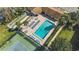 A scenic aerial view featuring a sparkling pool, tennis court and shuffleboard at 501 E Bay Dr # 102, Largo, FL 33770