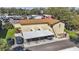 Aerial view of condo with parking, landscaping, and nearby businesses at 501 E Bay Dr # 102, Largo, FL 33770