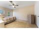 Cozy bedroom with tile floors, a ceiling fan, and a sliding glass door for natural light at 501 E Bay Dr # 102, Largo, FL 33770