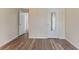Neutral bedroom features wood-look floors and a closet with mirrored door at 501 E Bay Dr # 102, Largo, FL 33770