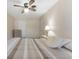 Bright bedroom with tiled floors, a ceiling fan, and natural light from the window and door at 501 E Bay Dr # 102, Largo, FL 33770