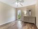 Bright bedroom featuring wood-look floors, a dresser, and a window with a view at 501 E Bay Dr # 102, Largo, FL 33770