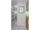 Hallway leading to laundry area with tile flooring and a glimpse of the dining room at 501 E Bay Dr # 102, Largo, FL 33770