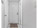 Clean, bright hallway with tile flooring and a simple white door, offering a minimalist aesthetic at 501 E Bay Dr # 102, Largo, FL 33770