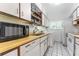 Compact kitchen features white appliances, ample counter space, and a convenient laundry area at 501 E Bay Dr # 102, Largo, FL 33770